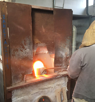 Melting of the glass. Melter put into furnace the glass batch.